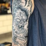Healed tattoo of a Japanese Oni Demon with spiked bat, on an upper arm. Tattooed at Cult Classic by Antony Dickinson