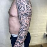 black and grey realism sleeve, with script tattooed in romford, essex at cult classic tattoo