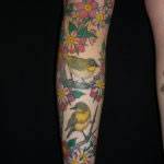 full colour japanese leg tattoo with yellow bird and pink cherry blossom on womans leg tattooed in romford, london, essex by aaron hewitt at cult classic tattoo