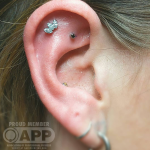 Curated ear with luxury jewellery Luxury piercing by Joe Espin, APP affiliated piercer at Cult Classic Tattoo in Romford, Essex just outside of London