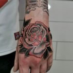 Fine line black and grey rose with a hint of red. Tattooed on a man’s hand by Antony Dickinson at Cult Classic Tattoo in Romford Essex