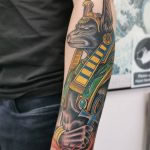 A man's forearm, tattooed with a rendition of Anubis, in a western traditional style by Ant Dickinson - northernbuilt at Cult Classic Tattoo