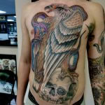 A full front and sleeve, tattooed in a western traditional style by Ant Dickinson. The man's front is a large eagle, standing on a skull, battling with a snake.